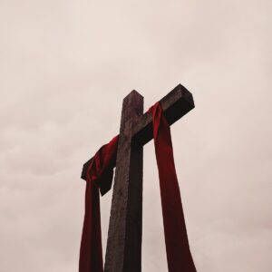low angle view of cross with red garment
