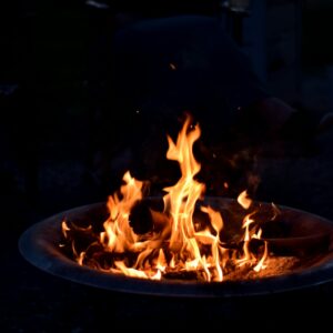 a close up of a fire pit in the dark